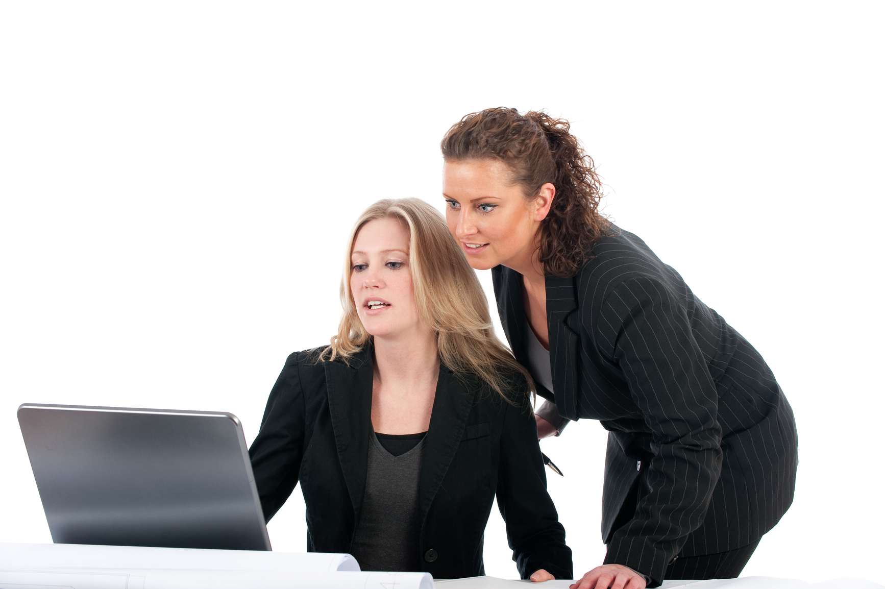 Two young business women working in the office with laptop
